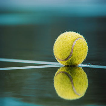 A tennis ball on a court